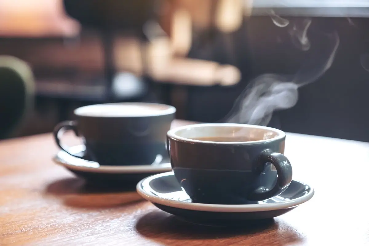 Coffee cup on a table at a neighborhood café, evoking walkable coffee convenience in the Hays Farm living area